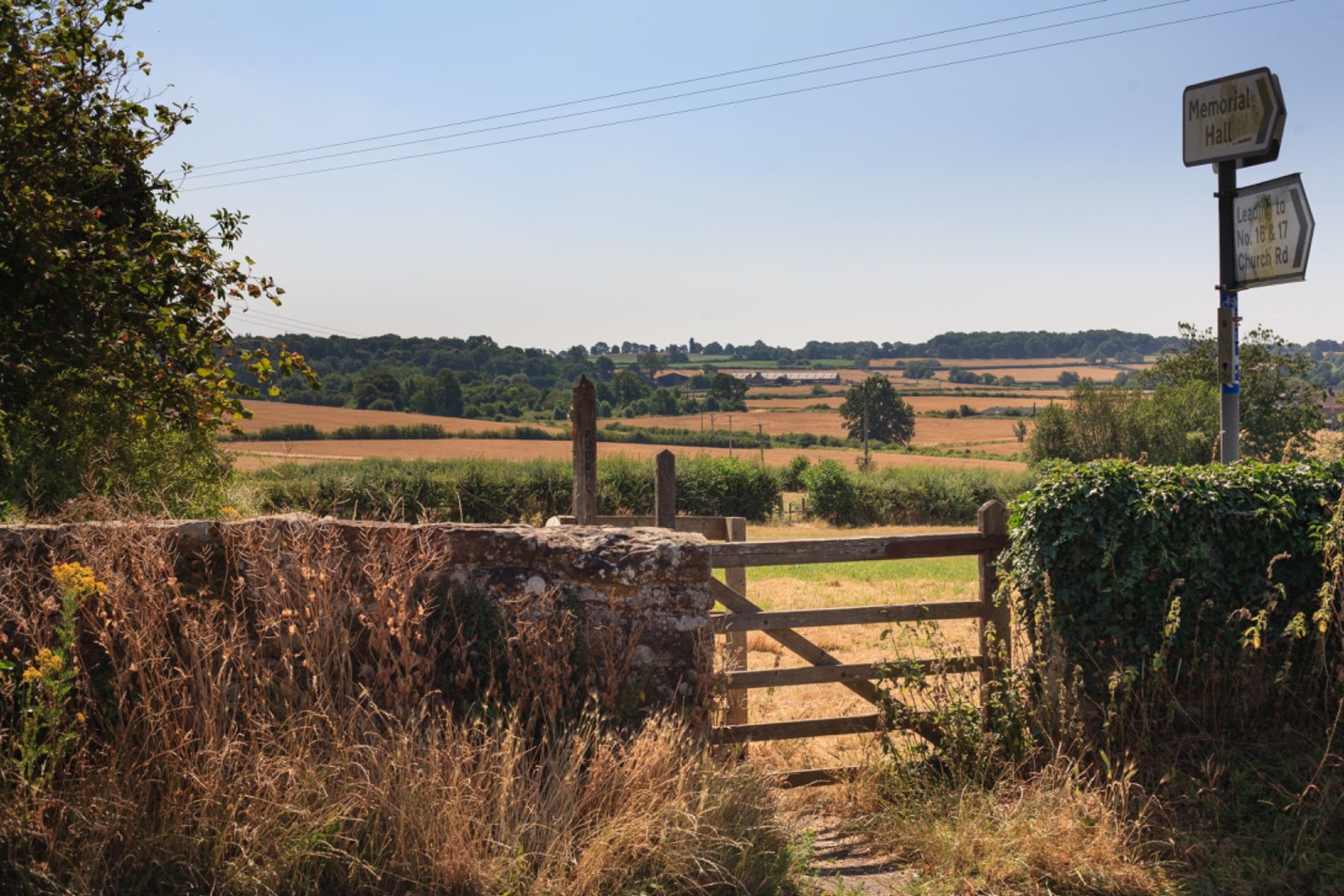 Gate and landscape with road signs in Shropshire